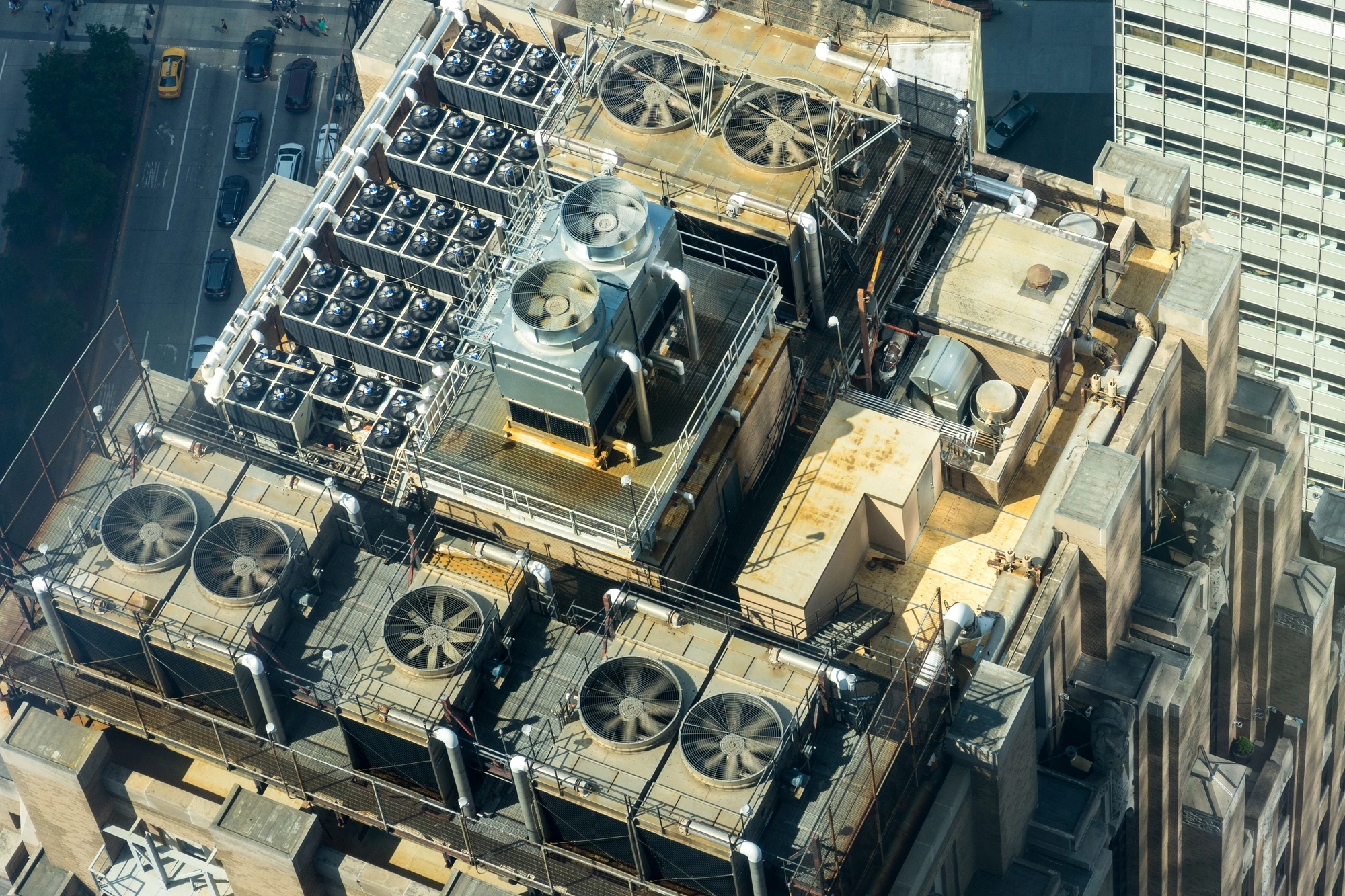 Aerial view of commercial rooftop HVAC equipment including cooling towers and condensers